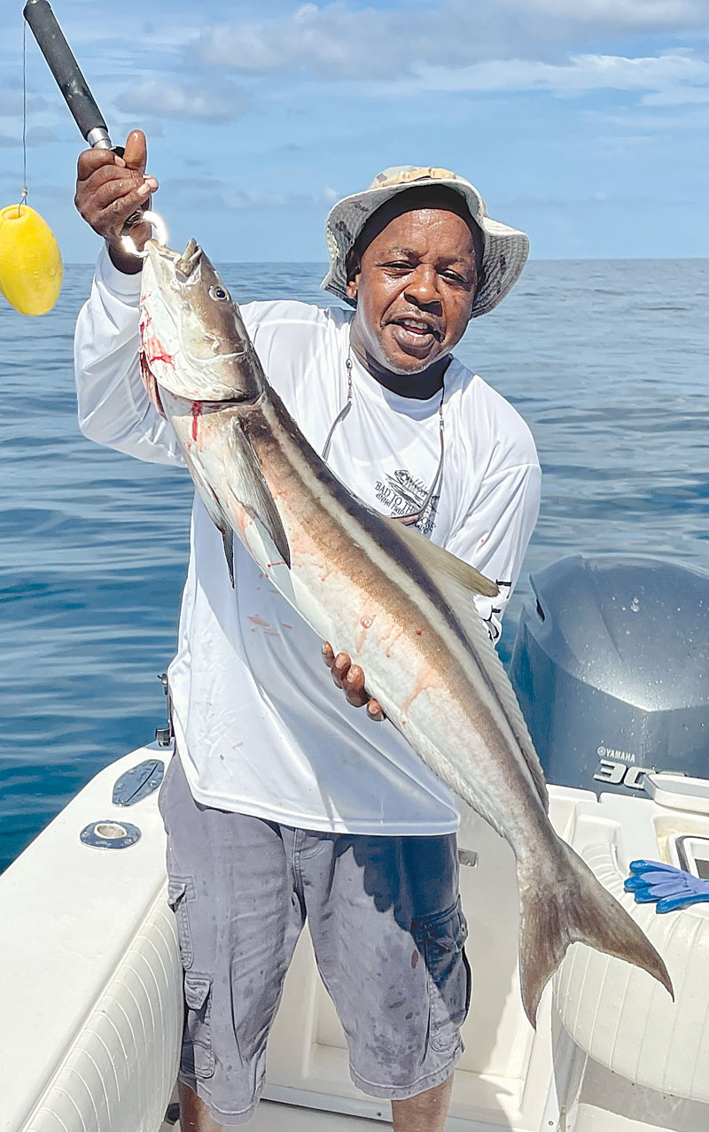 Portrait of a local fisherman holding his catch.